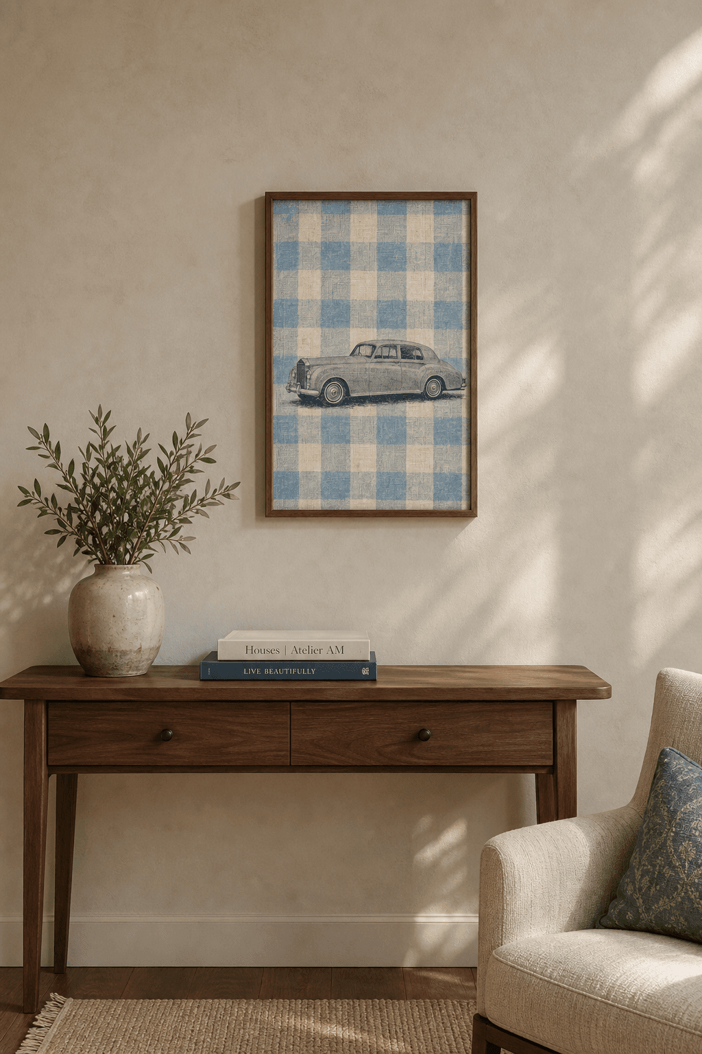 Rolls-Royce Silver Cloud III artwork displayed in a natural walnut frame above a console in a warm neutral living room.